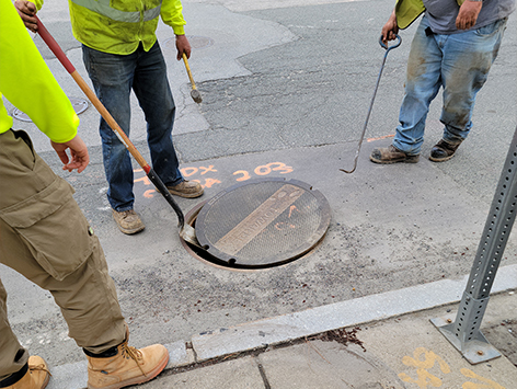 <b>Relocation of HEX manhole C19BA-203:</b>  Crews are inspecting the existing 2'x3'x2'D manhole for demolition.