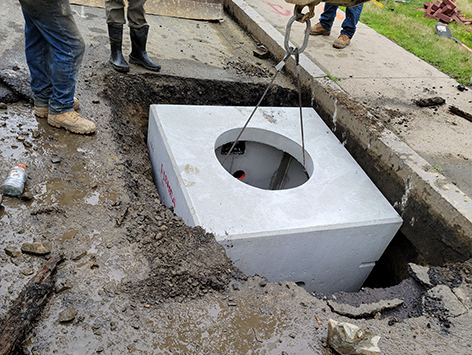 <b>Relocation of HEX manhole C19BA-203:</b>  Setting down the new replacement 4'x4'x4'D vault for manhole C19BA-203.
