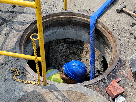 South facing wall of manhole C19BA-203 is removed to support mating of (15) 4 inch ducts and (4) 1.25 ducts from the mainline trench.