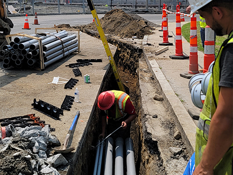 Crews are installing southbound (15) 4 inch ducts and (4) 1.25 inch ducts at manhole C19BA-203 for the mainline trench.